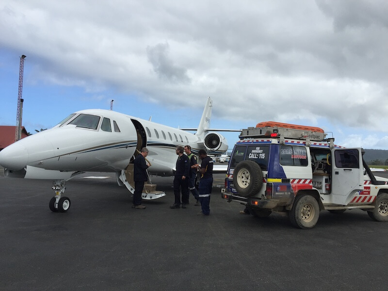 Australian air ambulance collecting a patient from a 4WD ambulance