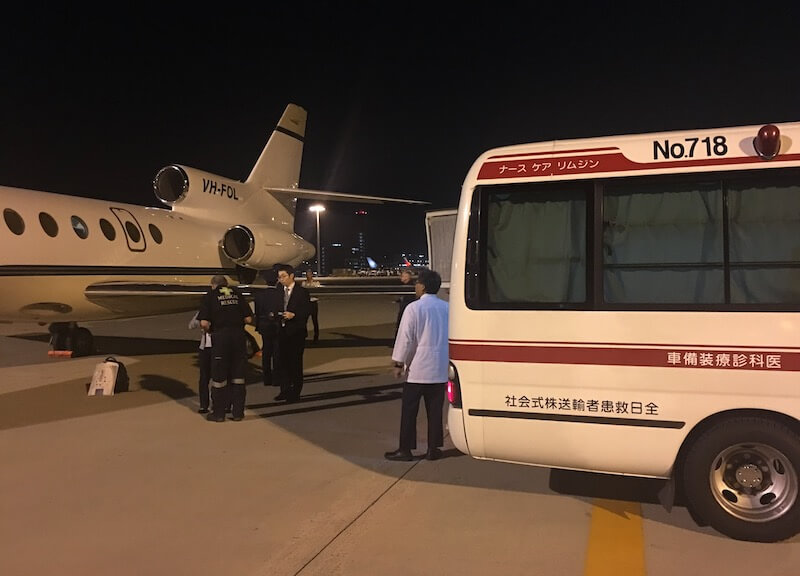 Air ambulance transferring a patient on the runway in Japan