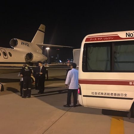 Air ambulance transferring a patient on the runway in Japan